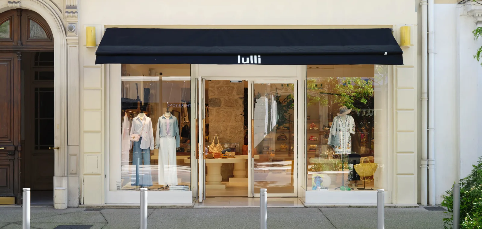 Front of the Lulli boutique in Nice, black awning and windows dressed with summer pieces
